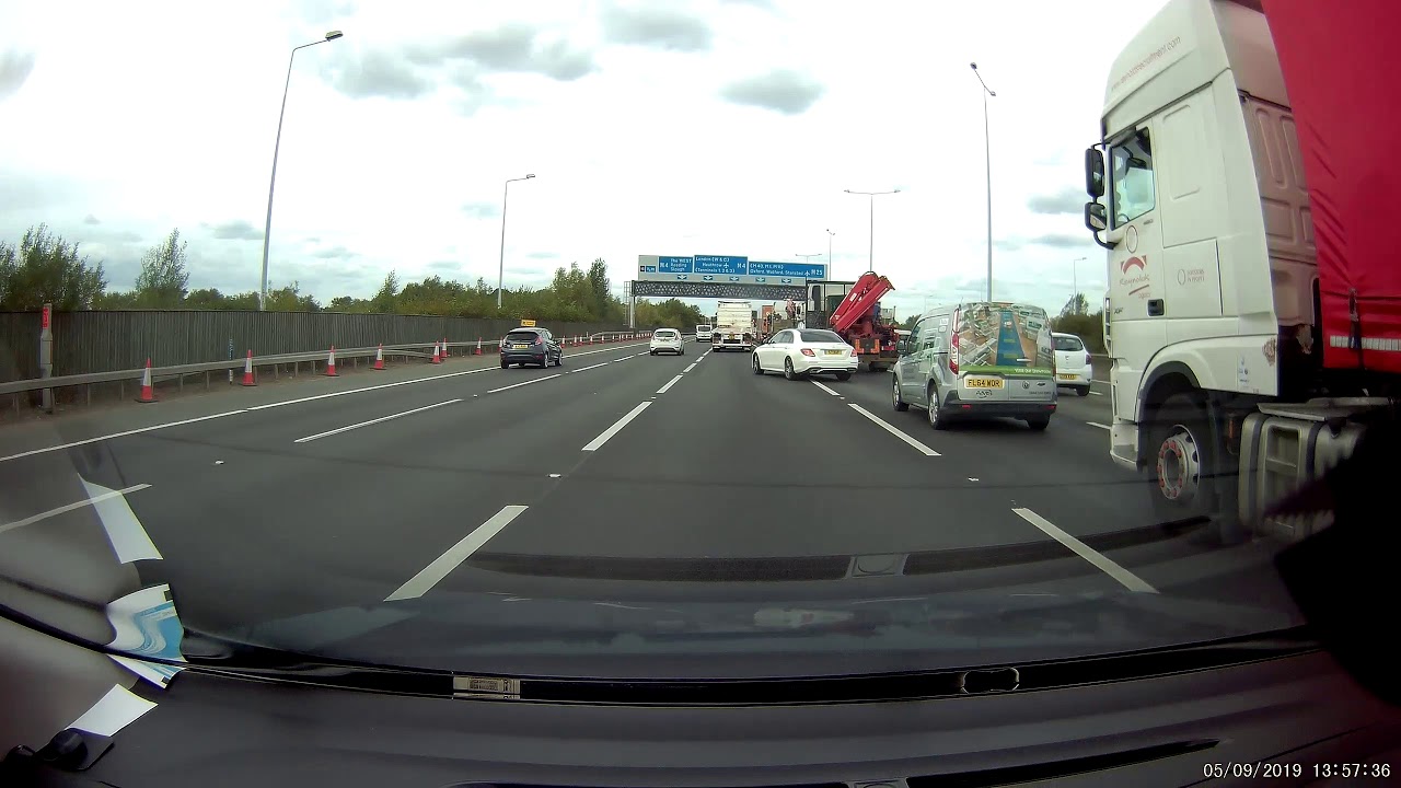 Mercedes nearly gets flattened by truck