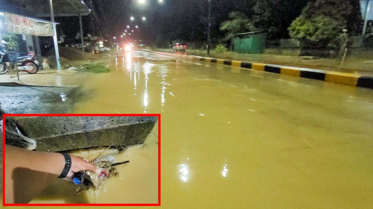 Unclogging Culvert To Drain Flood Rain Water Out From Street Road At ...