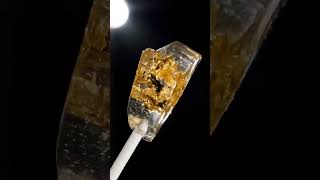 Rock-candy lollipop with gold flakes suspended spins ✨ #asmr #foodasmr #satisfying #shorts