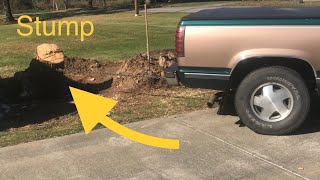 PULLING a tree stump out of the ground with a  PICKup TRUCK