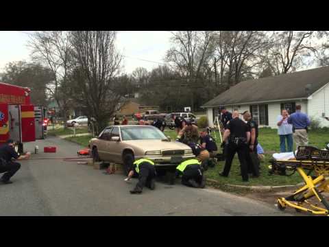 Police, fire rescue man trapped under car