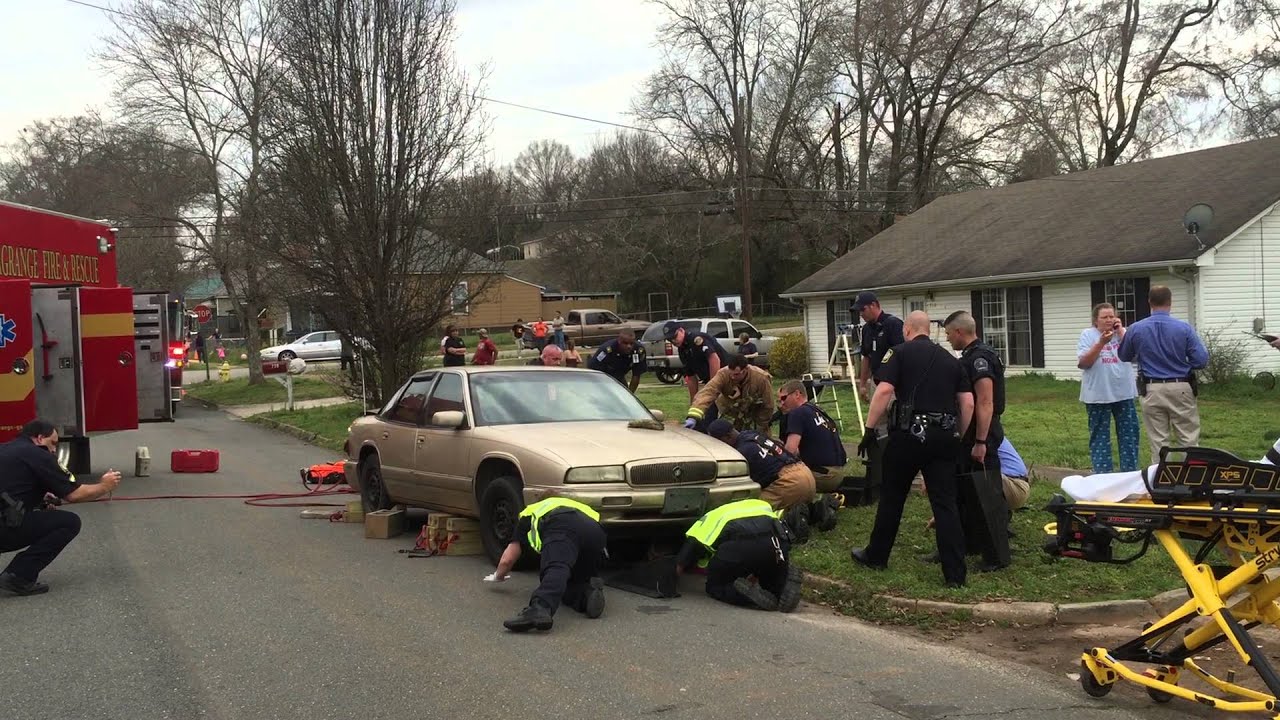 Police, fire rescue man trapped under car - YouTube