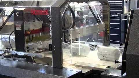Automated shrink wrap machine and oil filter shrink wrapping