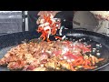 Cooking Spanish Paella with Chicken, Chorizo Sausage and Rice. London Street Food