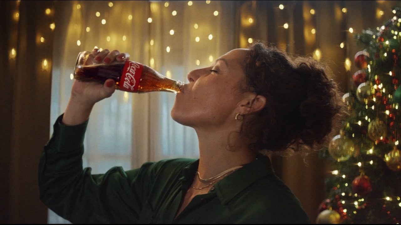 Woman drinking a glass bottle of Coca-Cola