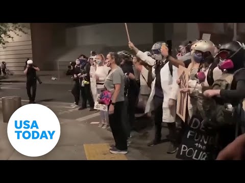 'Wall of moms' shields protesters saying 'leave our kids alone' | USA TODAY