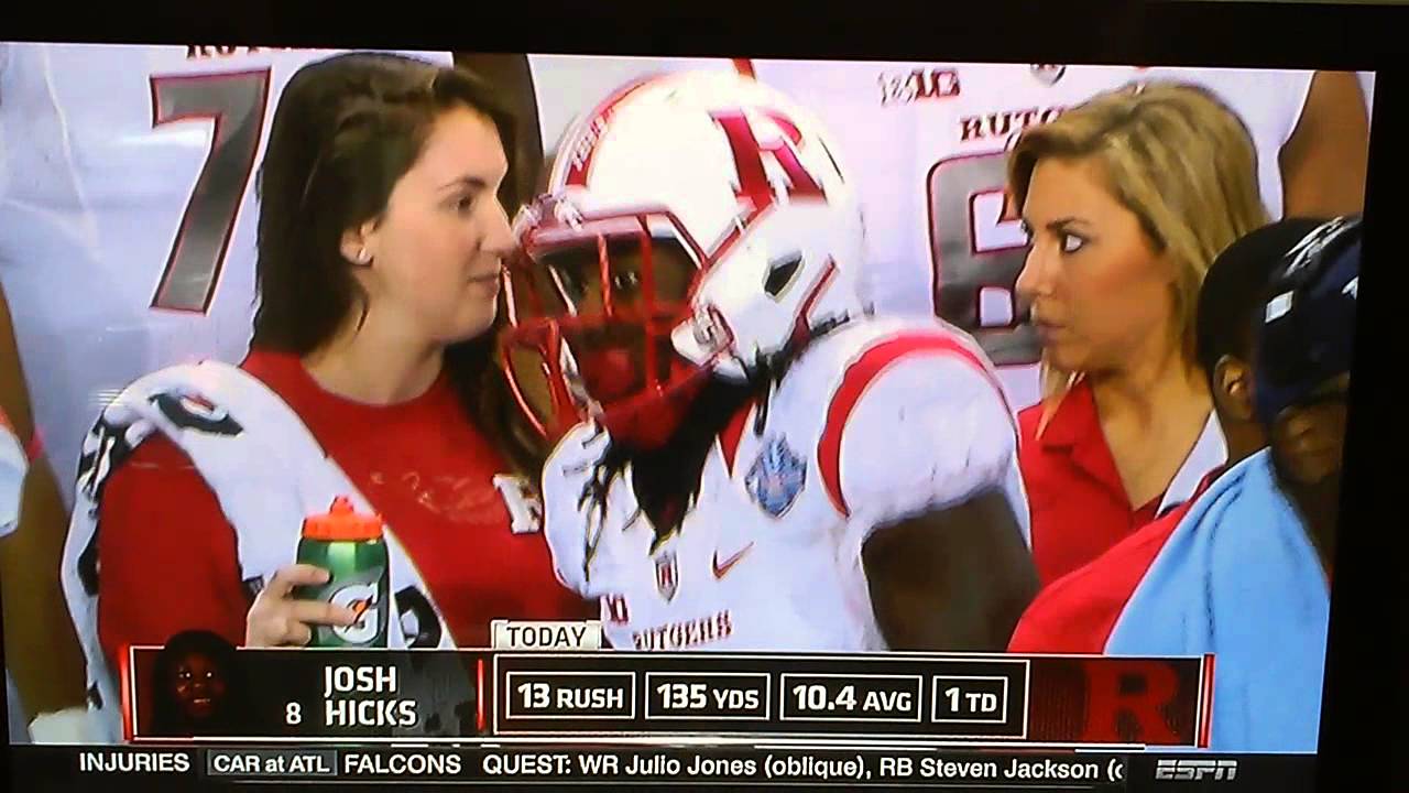 Rutgers water girls smile while player adjusting himself, extended