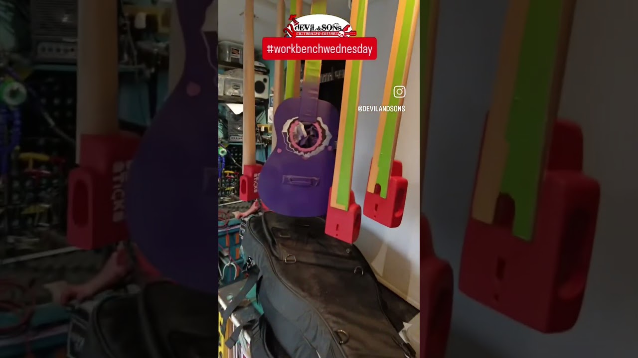 This luthier has a Hagstrom Electric and Acoustic Guitar on his workbench