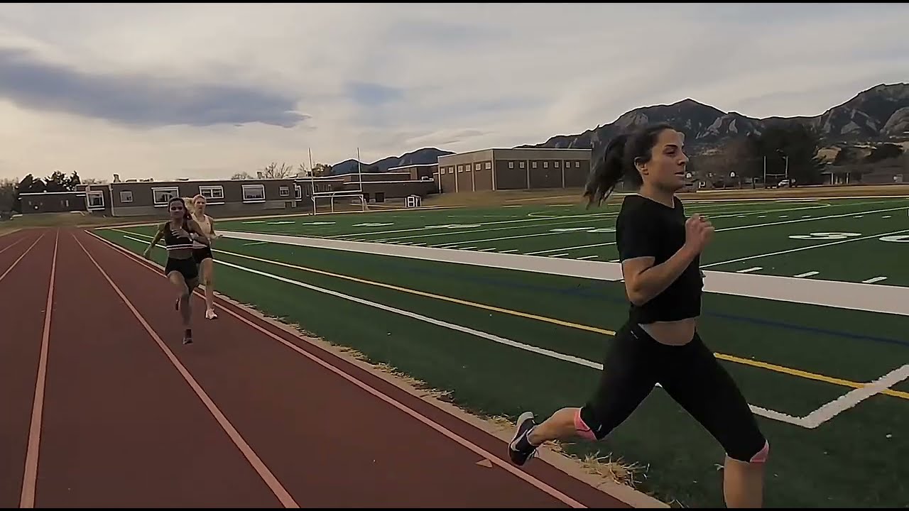 Girl runner in full black clothing hocks spit during training sesh