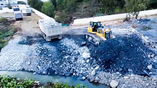 An Old Project With Huge Equipments Filling Mine Stones Into Water