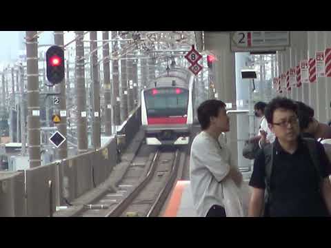 2023年開業の新駅「幕張豊砂駅」を通過していく京葉線上り快速E233系