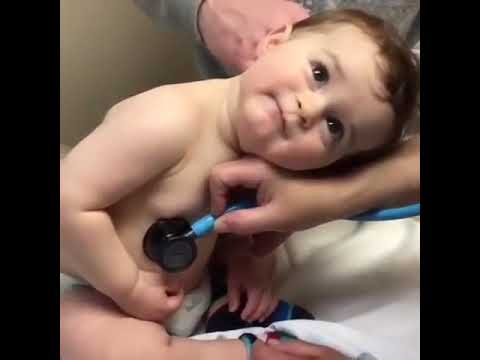 Sweet baby boy rests head on nurses hand