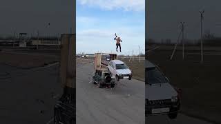 Man Jumps off a Car Situated Over a Frame Soon as Another Car Crashes It