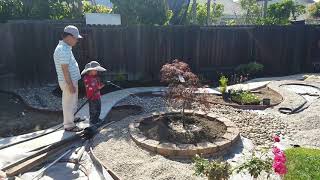 Caleb helping Ong May in garden