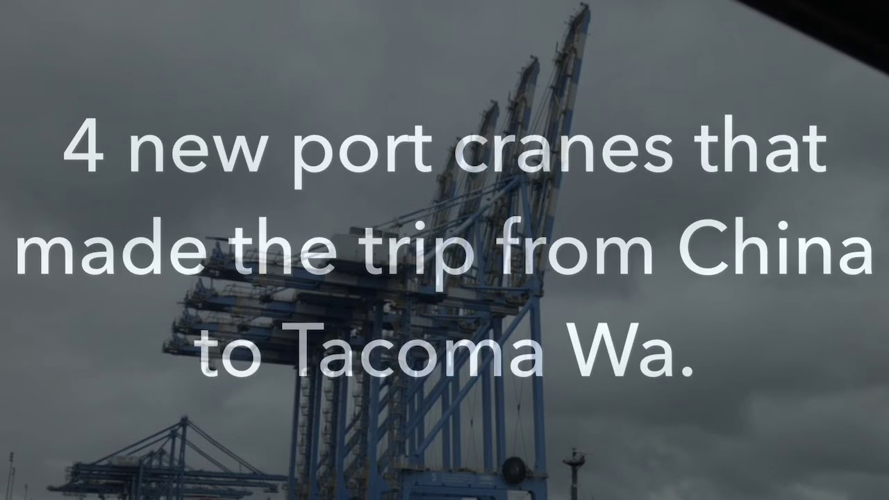 Off loading port cranes from a ship to dry ground.