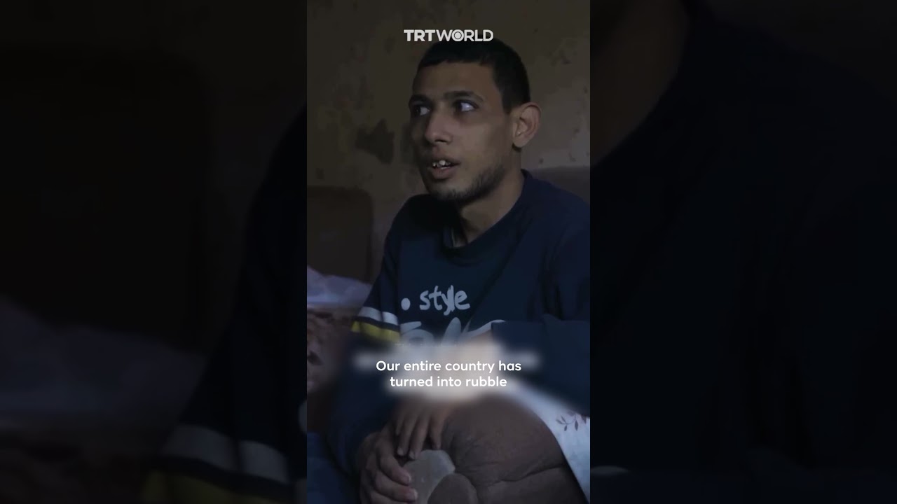 Displaced father in Gaza carries two special needs children amid war