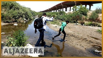 Migrants risk their lives by crossing dangerous river to reach US