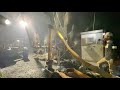 Small Mine Development employees hoist and lower flexible piping into the No. 2 well casing at the