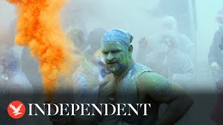 Greek revellers throw coloured flour at each other in 200 year old carnival tradition