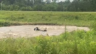 SUV upside down after being submerged by floodwater in Petal