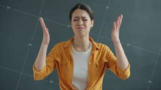 Portrait of desperate young woman frowning and flapping arms looking at camera with sadness