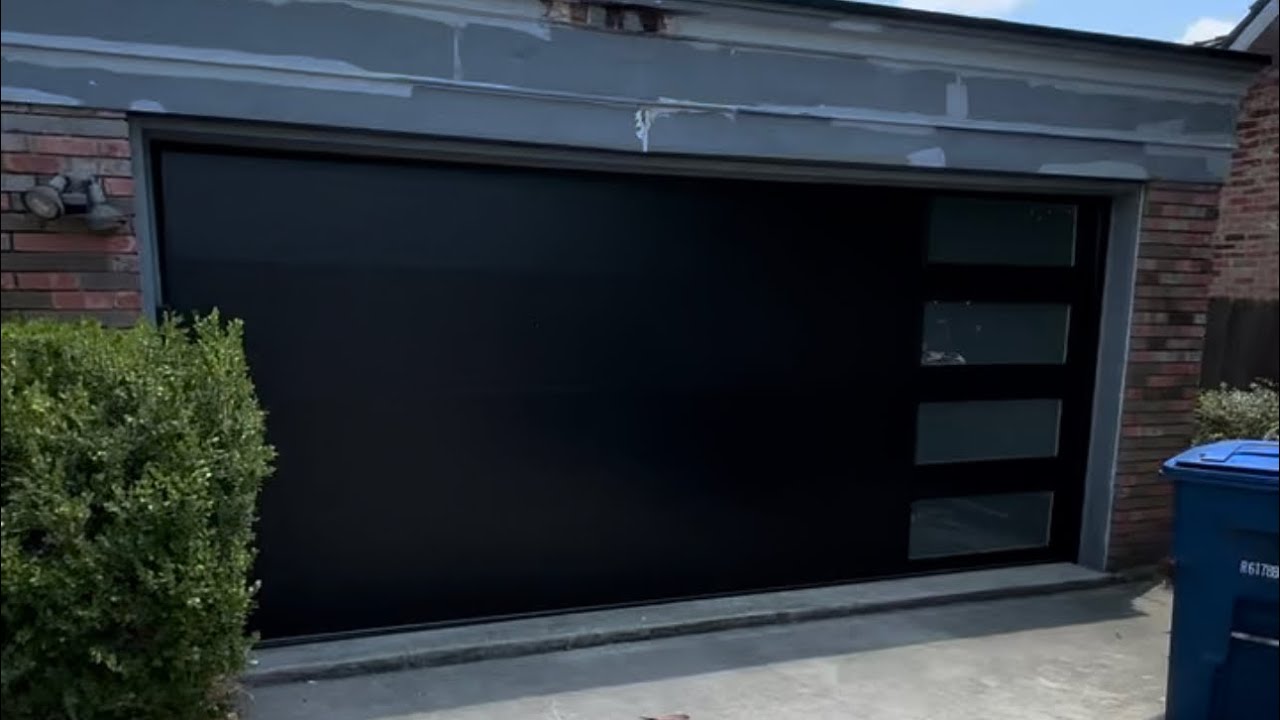 Check out our latest install! CLOPAY Modern Flush Black door with vertical frosted windows!