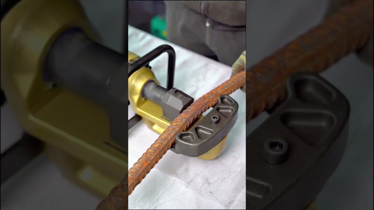 Bending rusted rebar with a powerful hydraulic machine for construction shaping work