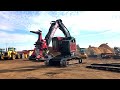 Timbco Feller Buncher unloading from a lowboy trailer