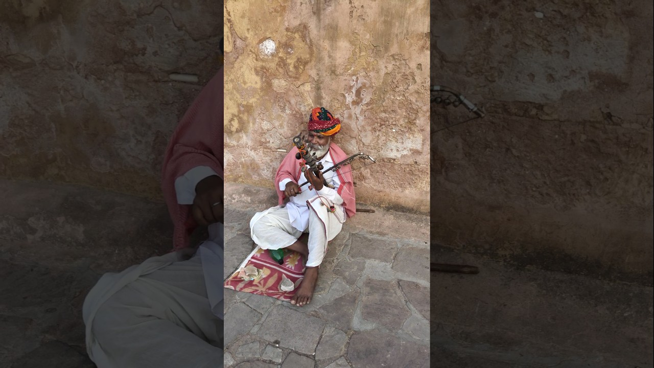 A local artist playing music at famous Amer Fort Jaipur