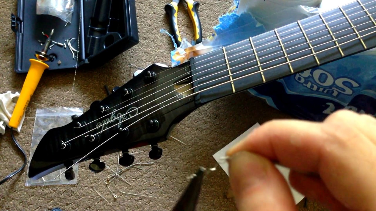 How to fit big guitar strings into tuning peg for doom or djent (no drilling)