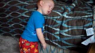 Baby sleeping while standing up.