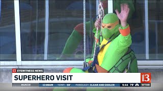 Superhero window washers visit hospital