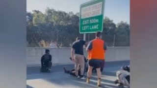 Furious drivers drag climate activist off busy road