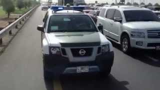 Dubai police car responding with ambulance