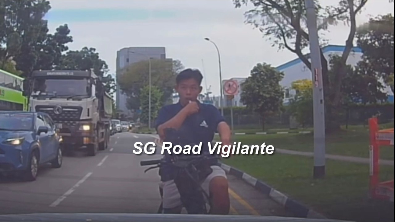 20jul2026  E-bike rider vaping no helmet, beat red light, overtaking heavy vehicle on the left