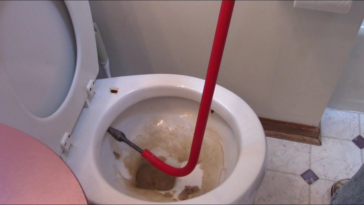 Using A Toilet Auger (Snake) On A Clogged Toilet - YouTube