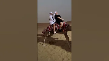 Suzzy & Jonah Riding A Camel In Dubai