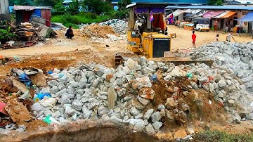 Looking good skill operator bulldozer working push clean Garbage and stone with dump truck unloading