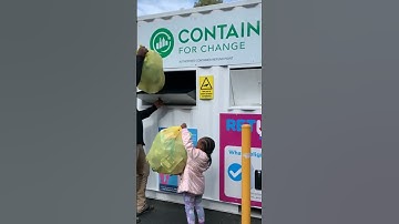 Recycling at the containers for change depot with daddy