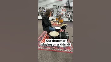 Playing a kids drum set