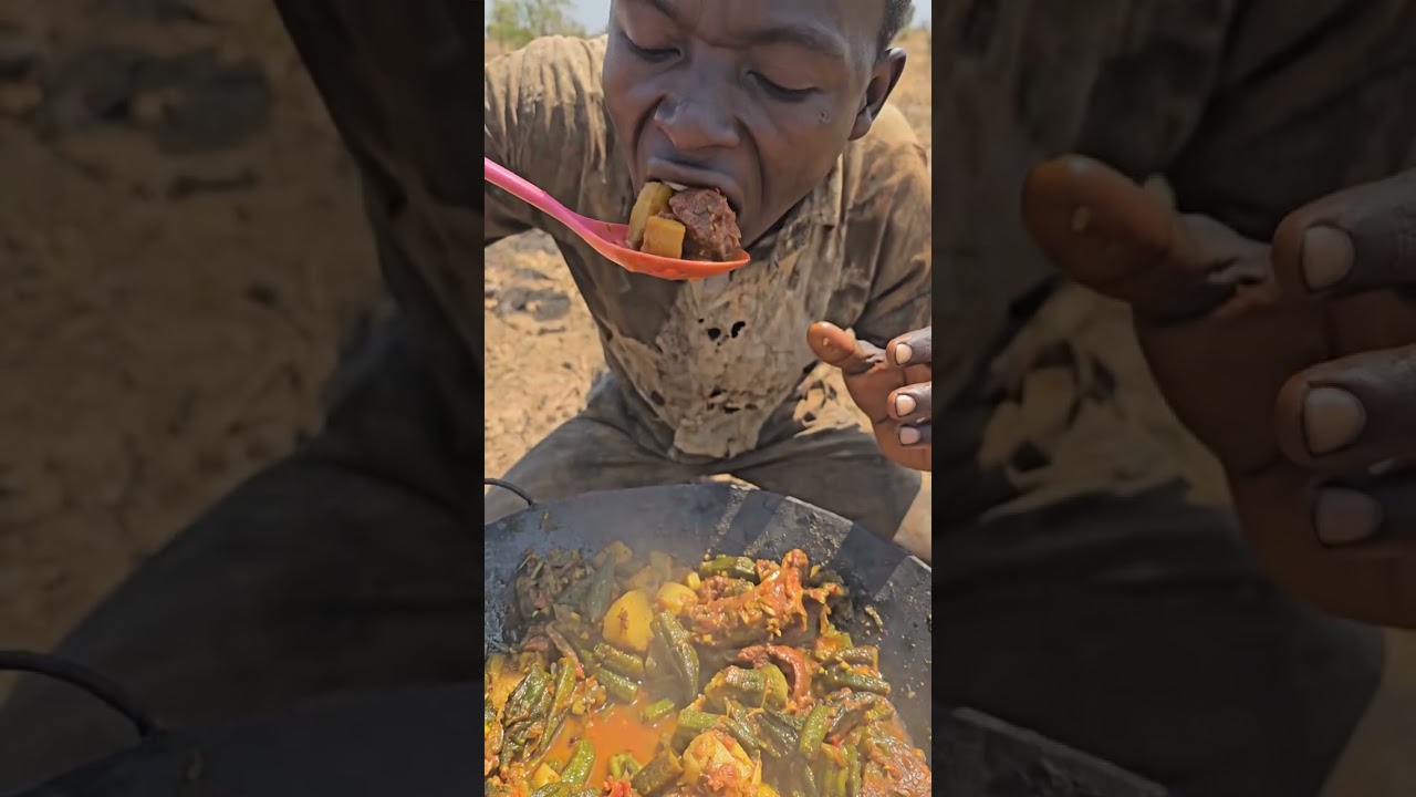 Hadzabe eating grilled fish cooked in primitive style.