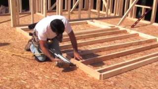 Watch a non-load bearing wall being constructed. See how to stack the wall studs with floor joists and what a typical door opening 