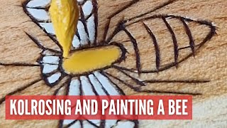 Kolrosing and painting a bee on a coffee scoop. Slow and relaxing process of decorating wood.