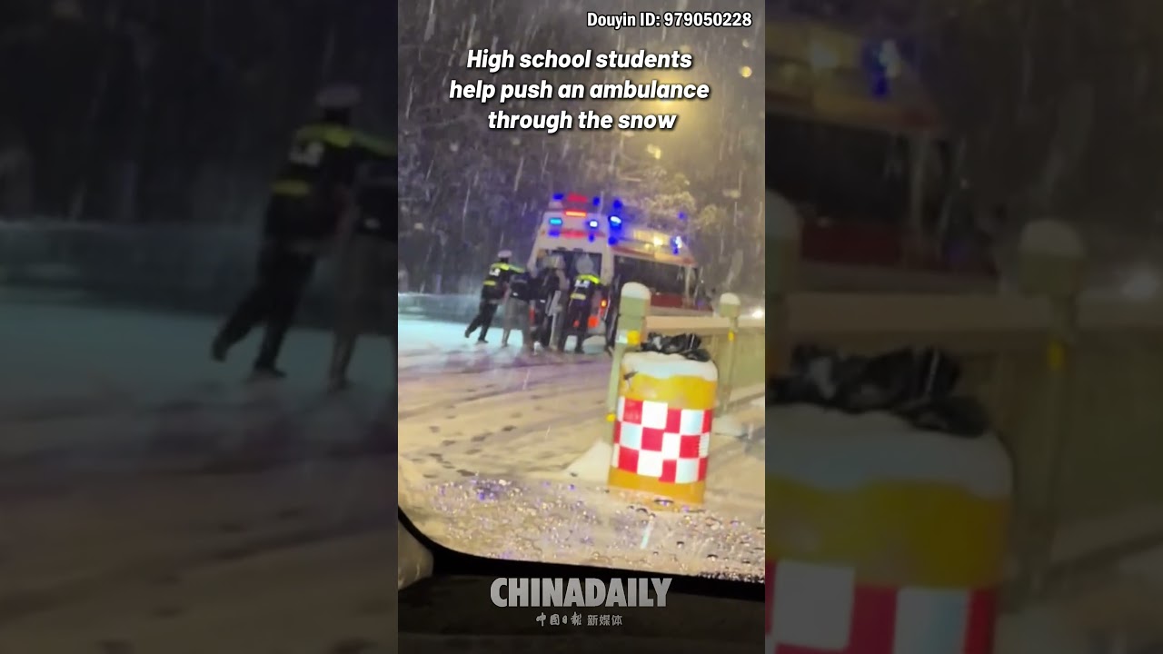 High school students help push an ambulance through the snow