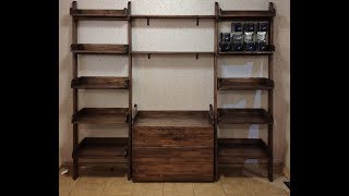 Деревянные полки и комод с наклонными опорами. Wooden shelves and chest of drawers