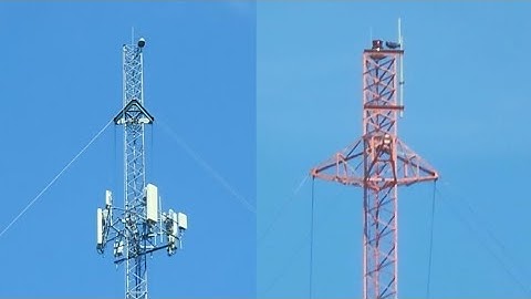 A guyed tower with an LED beacon and another guyed tower with a TWR E1DB xenon strobe 