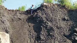 The process of lowering the rock from the top the cliff also splits the black rock