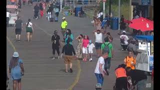 elderly lady with cane on Atlantic City boardwalk takes a tumble and is helped up