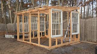 Framed greenhouse walls are up & old windows are going in.