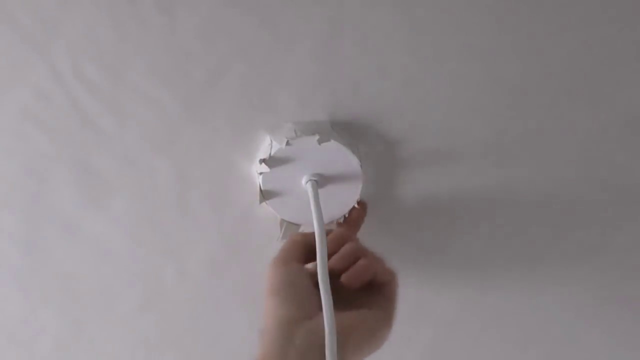 Applying Lining Paper To Ceiling Cutting Around Pendant Light Fitting
